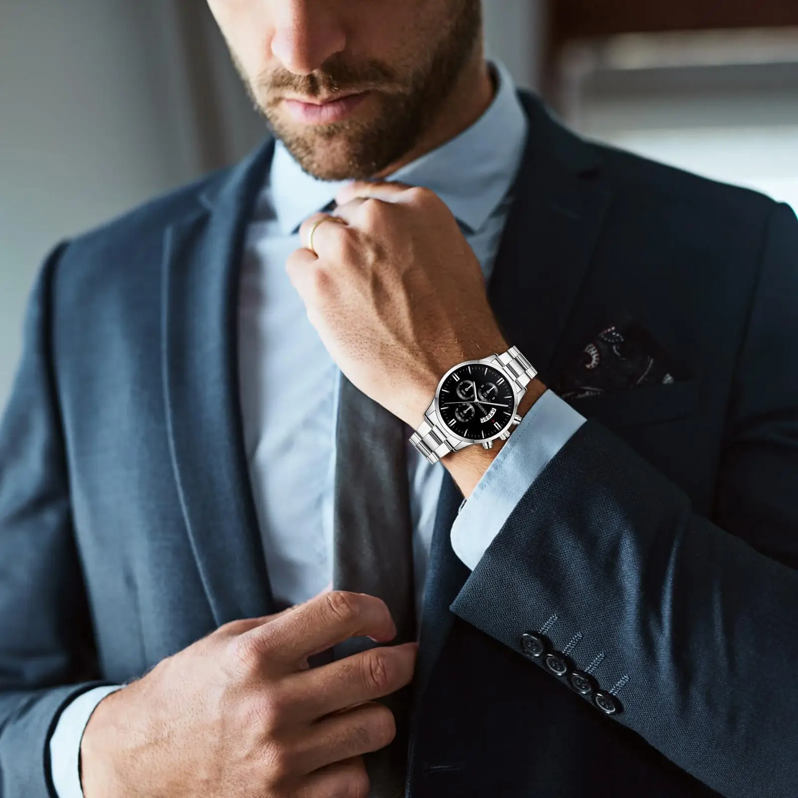 Man in a suit looking at his Aethel watch.