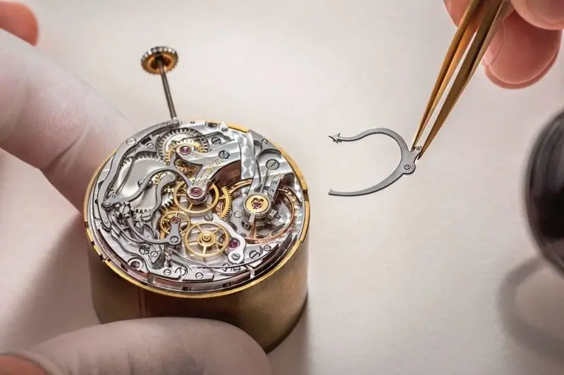 A master watchmaker assembling a movement.